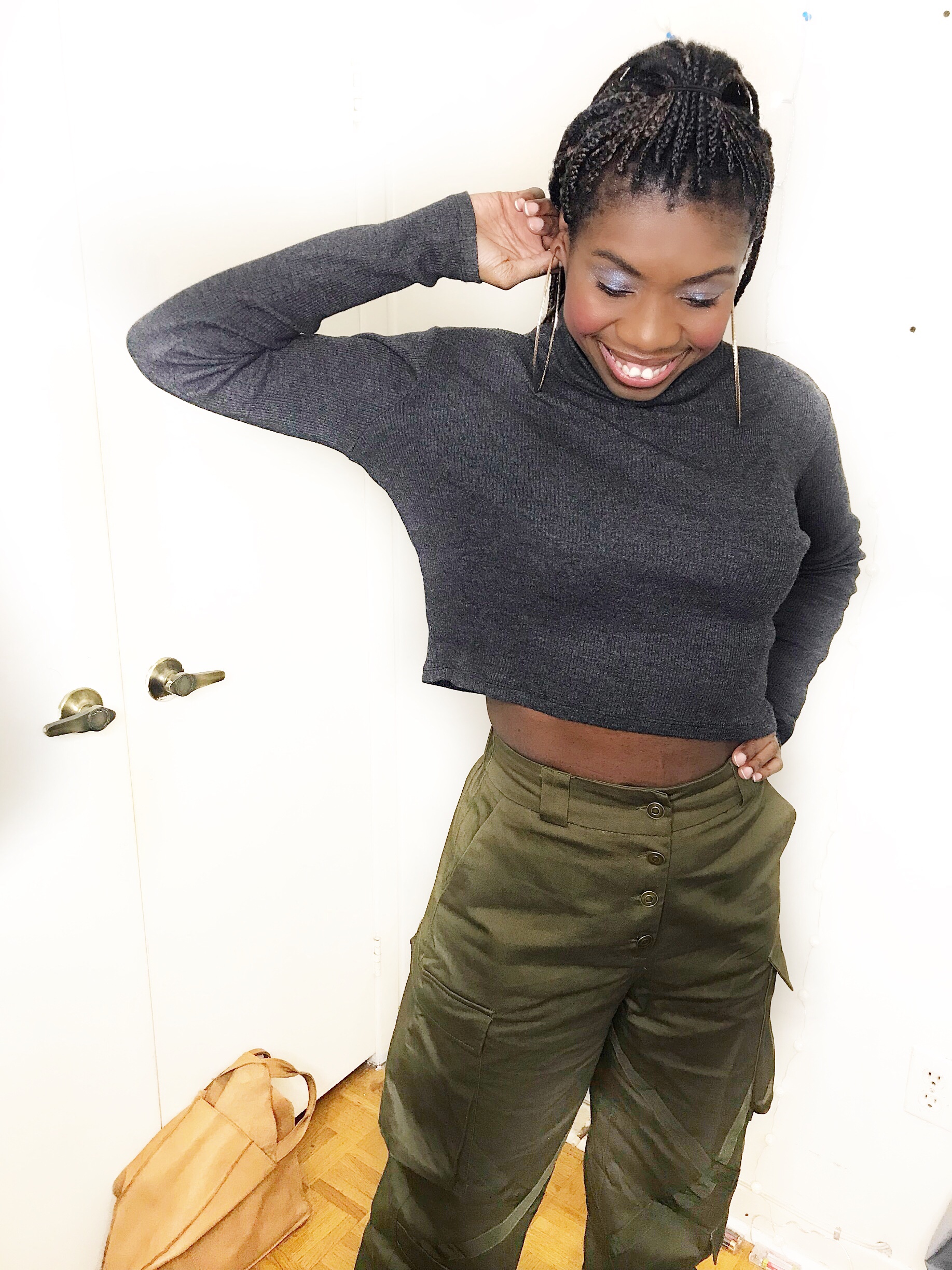 Telly smiles wearing her olive green combat pants