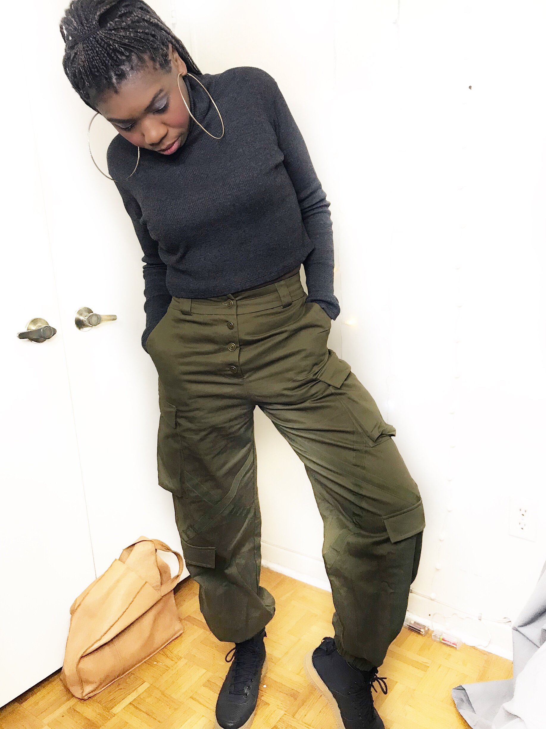 Telly poses in her olive green combat pants
